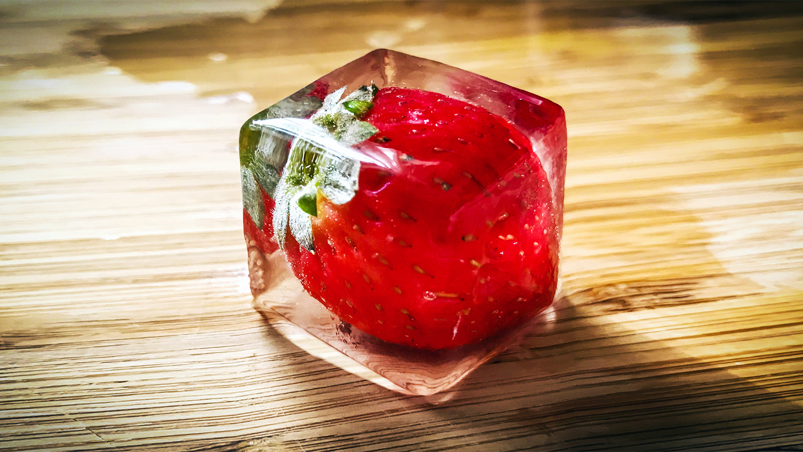 Strawberry frozen in a clear cube