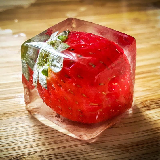 Strawberry frozen in a clear cube