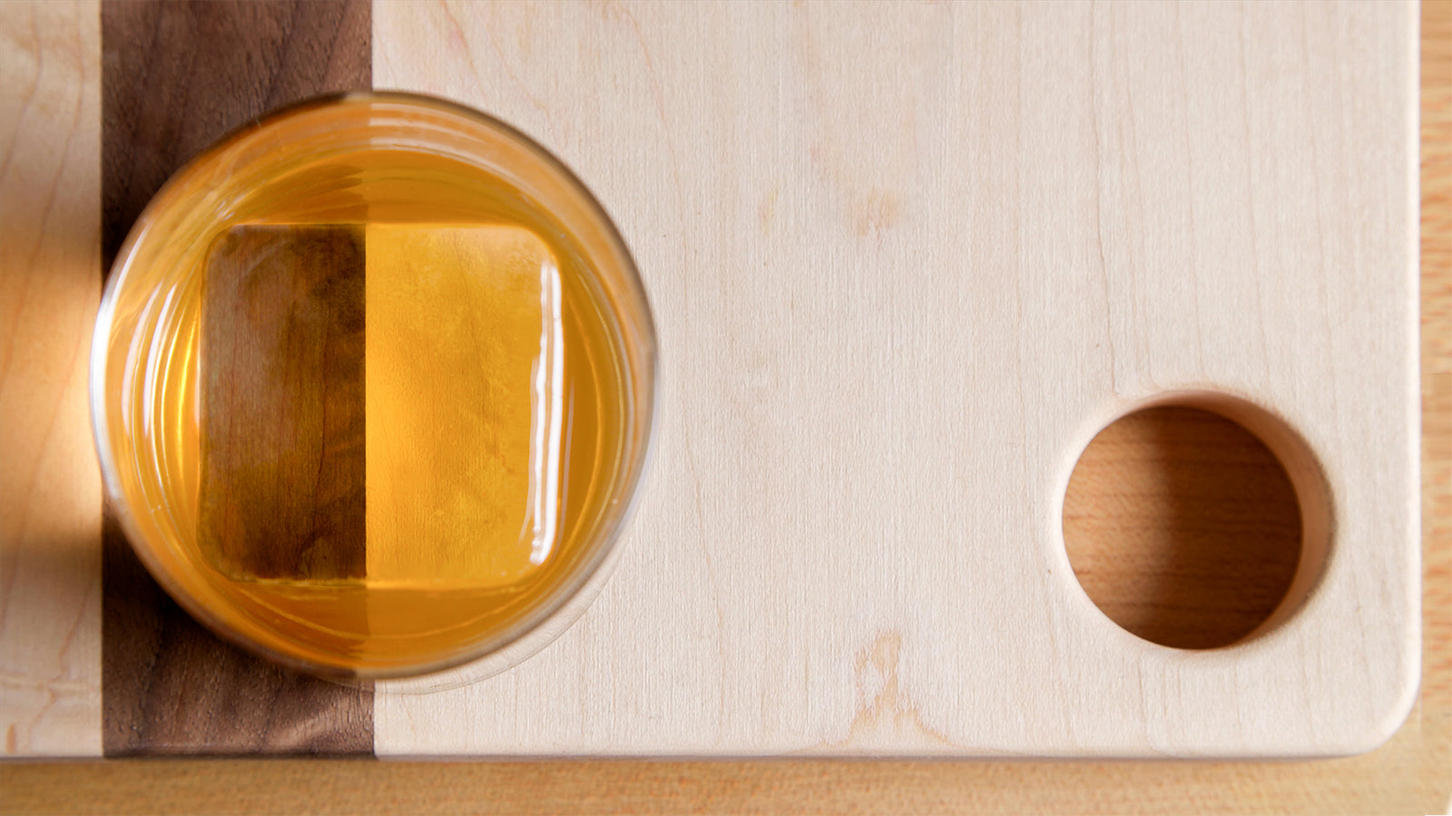 Top view of huge clear cube in Bourbon drink